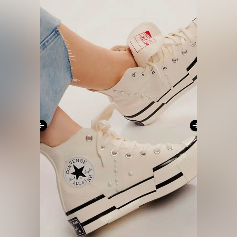 Converse Chuck Taylor high-tops in off-white with pearl detail. Lightly worn.